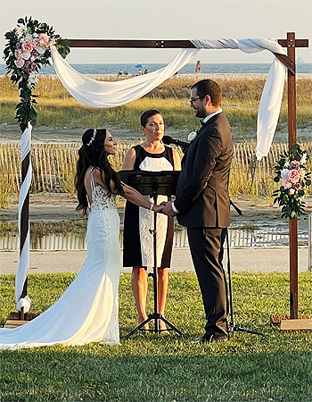Wedding ceremony officiant Reverend Loriann performing a wedding ceremony on a Long Island beach